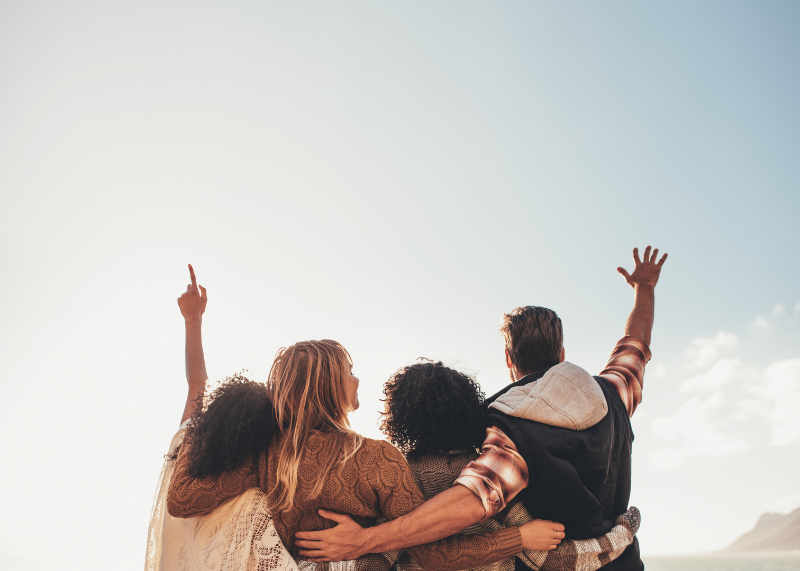 group of people with hands held high